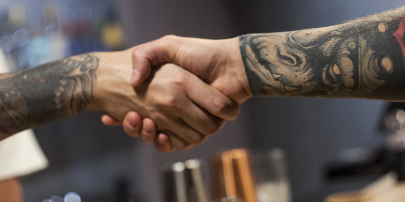 Business professionals shaking hands on a vending machine partnership agreement in Dallas-Fort Worth