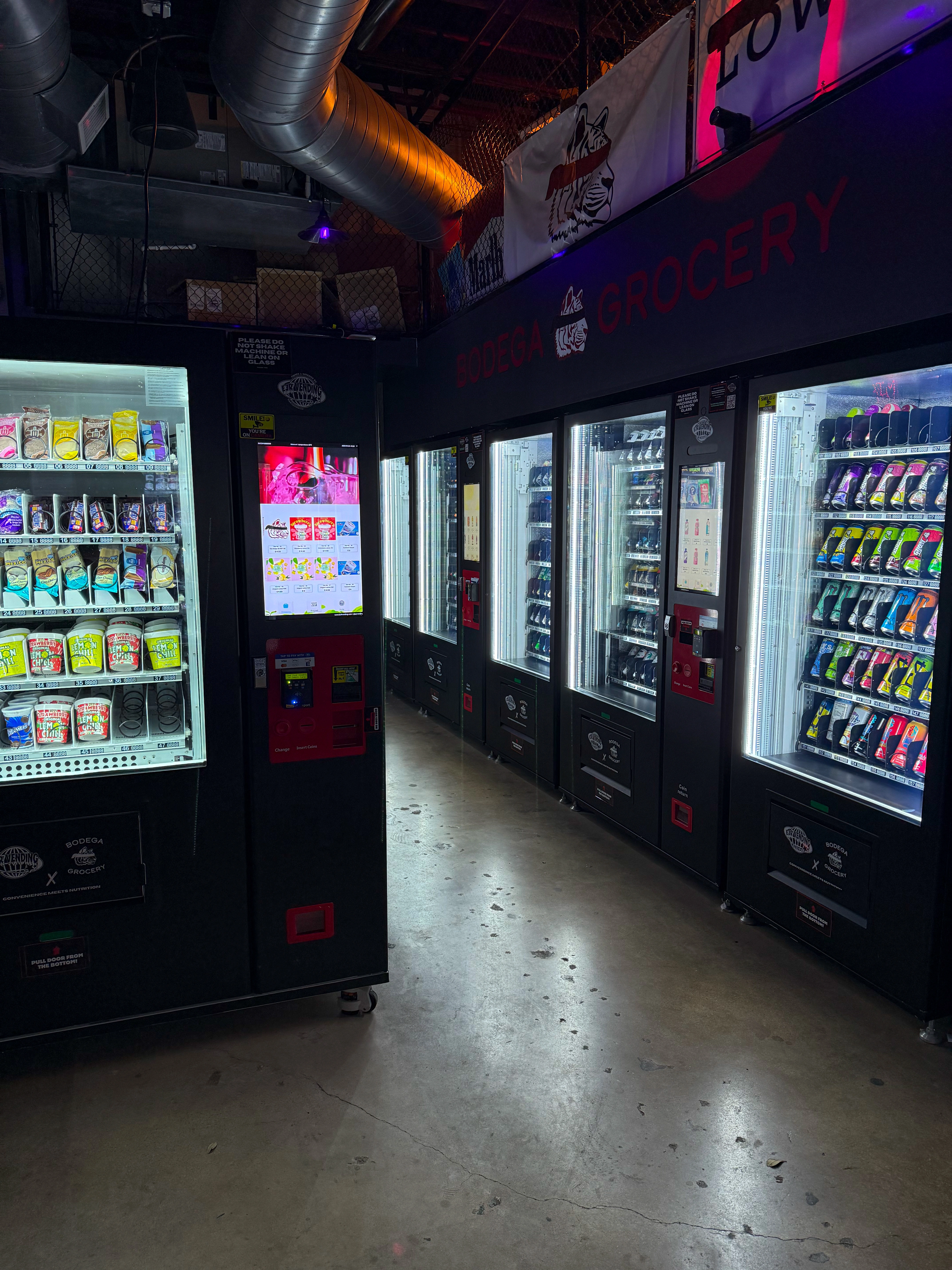Multi-machine vending corridor at Bodega W. 7th automated convenience store in Fort Worth showing secured alternative to micro markets in DFW