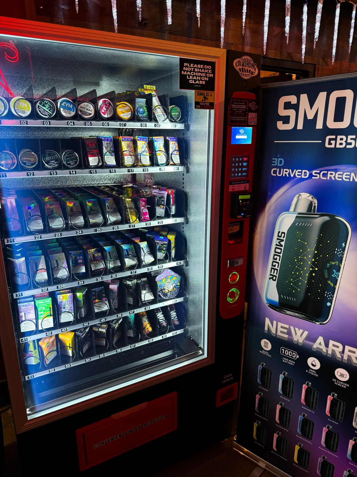 Age-verified vape vending machine with Smogger display stocked with nicotine pouches and disposables at a Dallas-Fort Worth bar