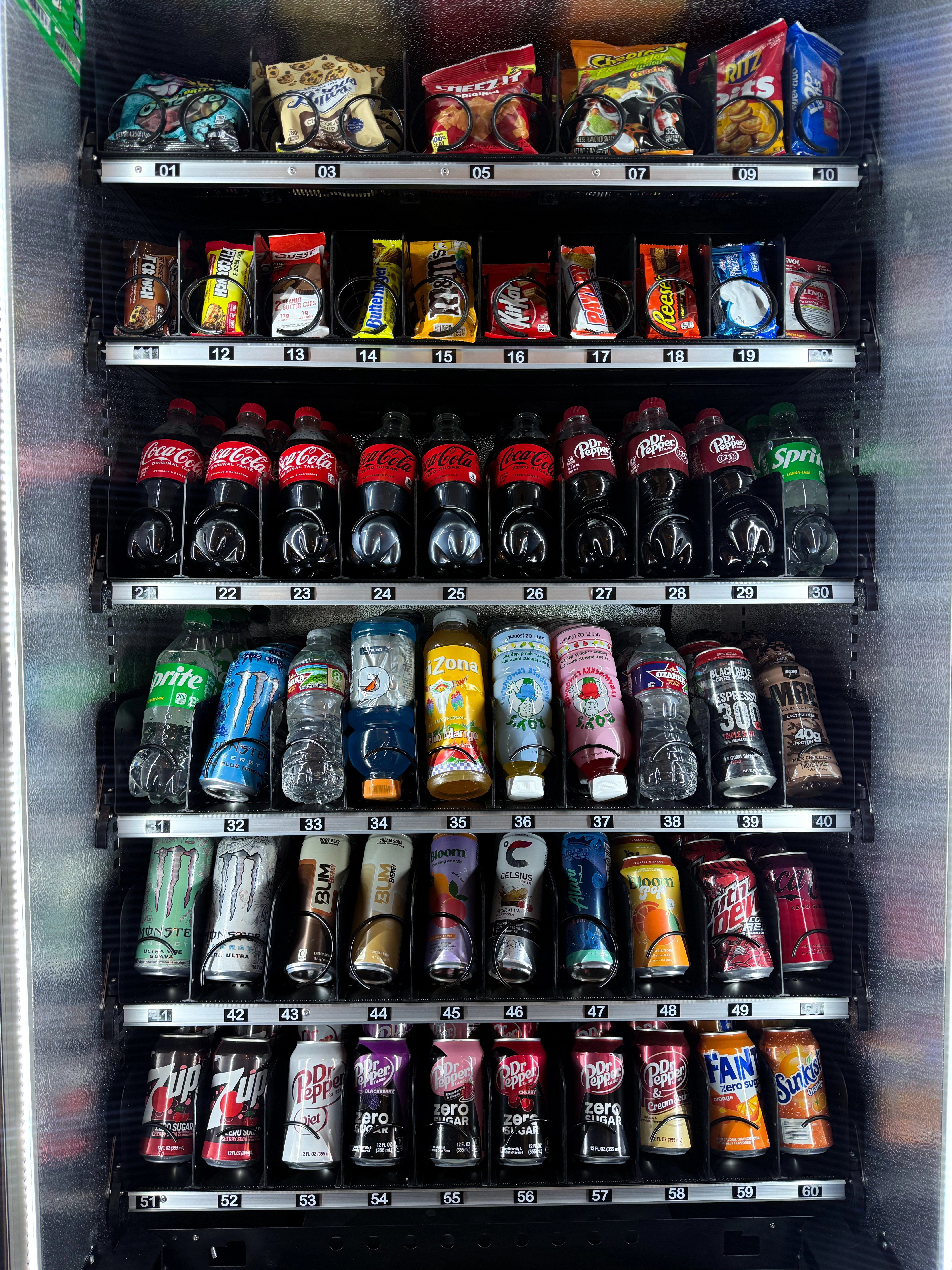 Modern EJR Vending combo machine stocked with snacks and beverages in a Dallas-Fort Worth office breakroom