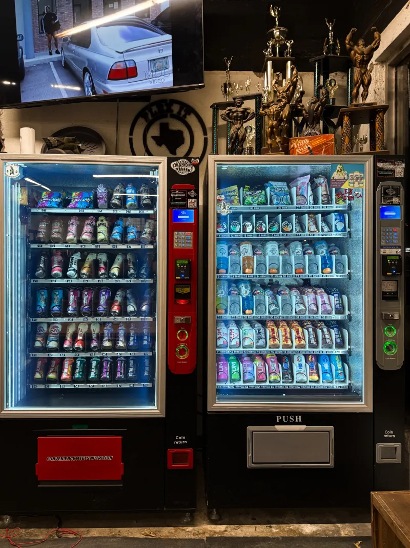 Dual EJR Vending machines stocked with drinks and snacks at a Dallas-Fort Worth gym