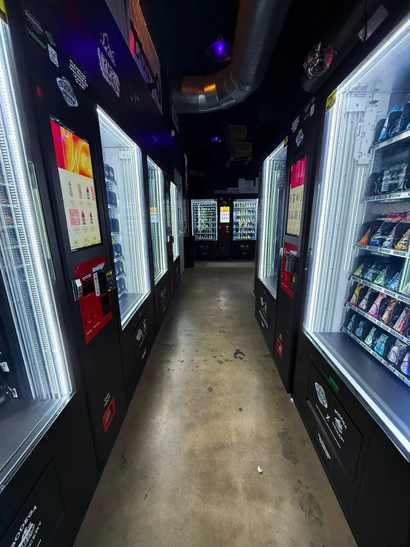 Corridor lined with EJR Vending machines at a DFW automated convenience store